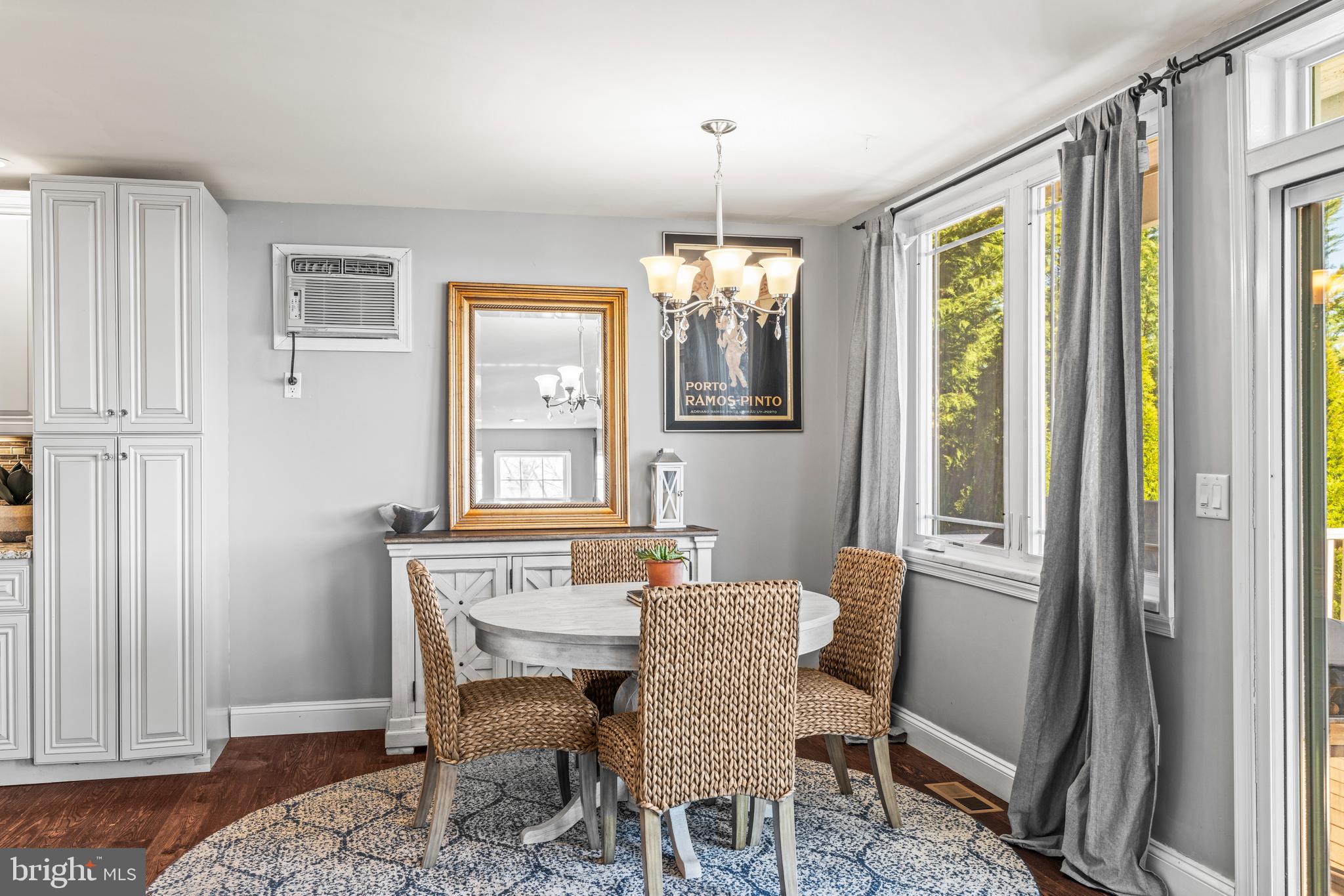 3930 Glenhurst Road Baltimore, MD 21222 - Photo 14 of 29 a dining room with furniture a chandelier and wooden floor