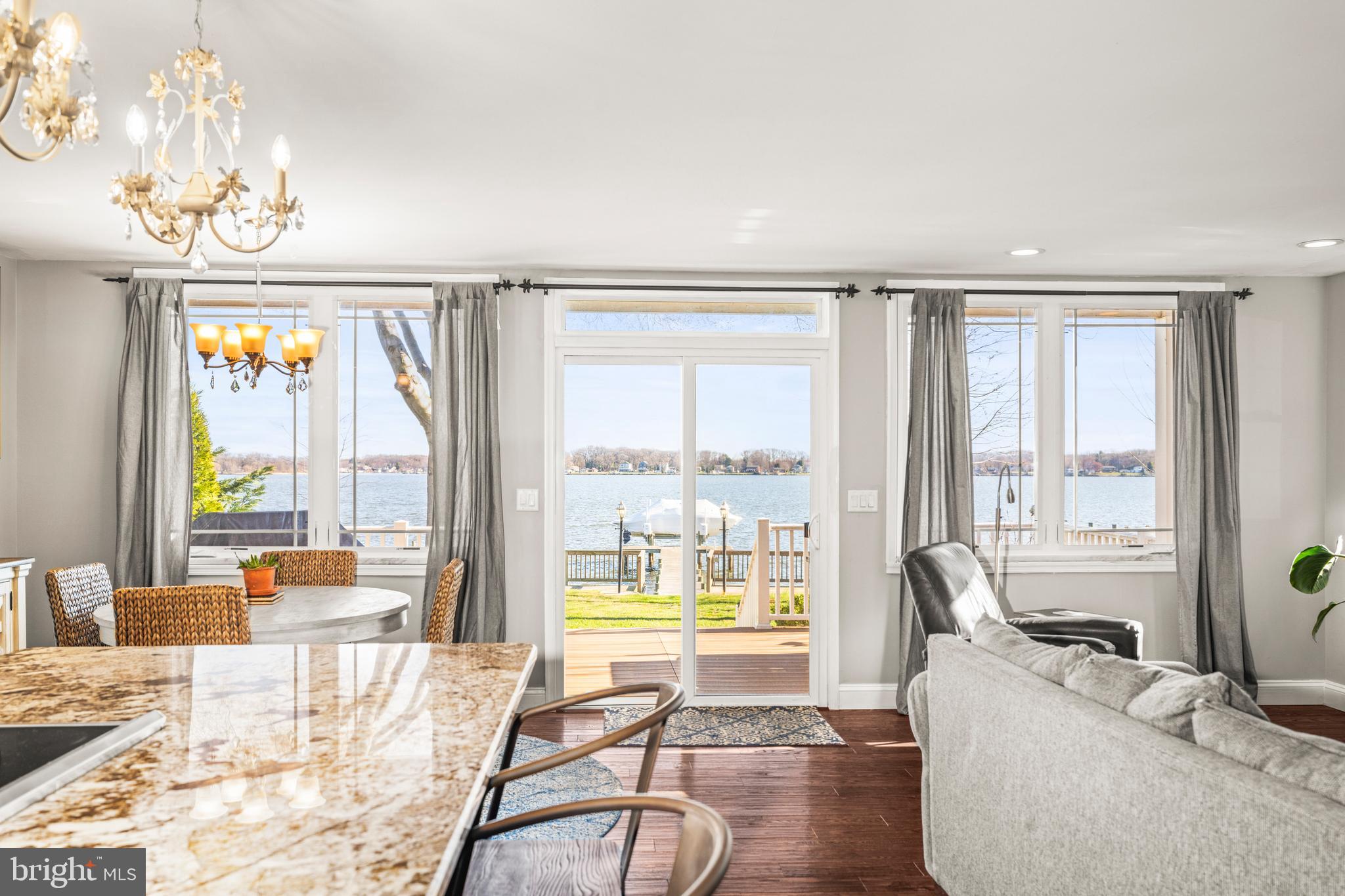 3930 Glenhurst Road Baltimore, MD 21222 - Photo 3 of 29 a living room with furniture and floor to ceiling windows