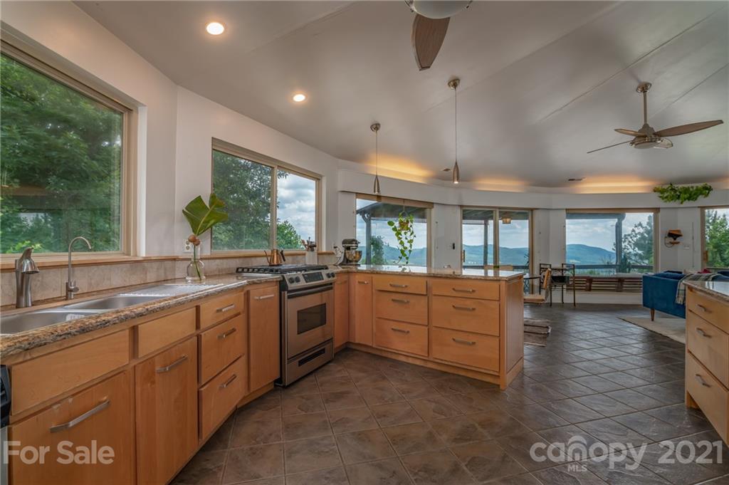 281 Big Rock Road Bostic, NC 28018 - Photo 15 of 48 a large kitchen with kitchen island a large window a sink and stainless steel appliances