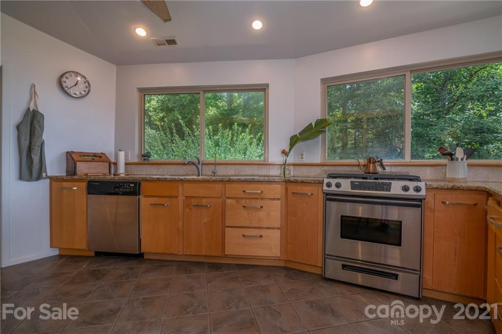 281 Big Rock Road Bostic, NC 28018 - Photo 16 of 48 a kitchen with granite countertop a stove a sink and a refrigerator
