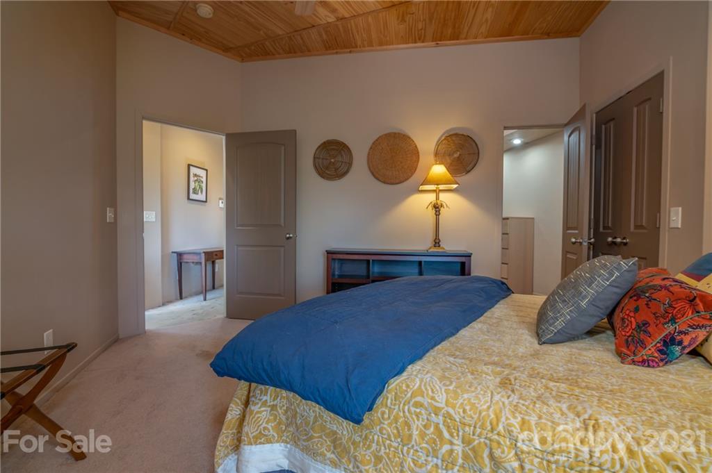 281 Big Rock Road Bostic, NC 28018 - Photo 24 of 48 a bedroom with a bed and a chandelier