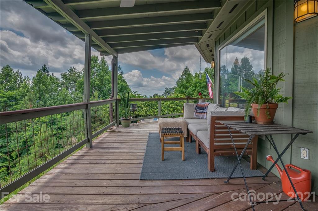 281 Big Rock Road Bostic, NC 28018 - Photo 39 of 48 a view of a patio with table and chairs potted plants with wooden floor