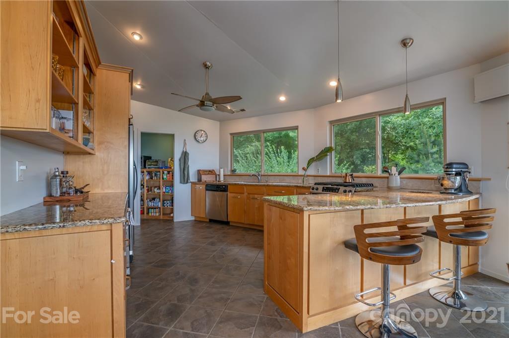 281 Big Rock Road Bostic, NC 28018 - Photo 6 of 48 a kitchen with kitchen island a large counter top space appliances and a center island