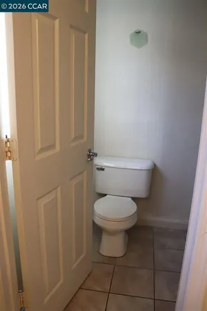 a white toilet sitting next to a shower