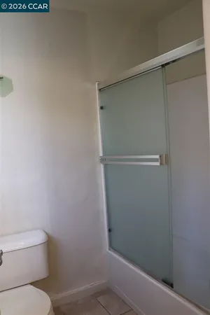 a bathroom with a shower and a toilet