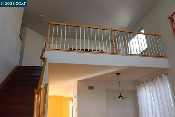 a view of entryway with a window and wooden floor