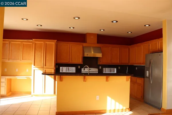 a kitchen with stainless steel appliances granite countertop a sink and cabinets