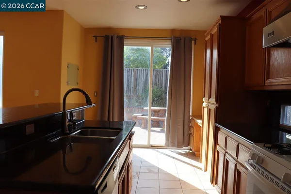 a kitchen with granite countertop a stove and a sink