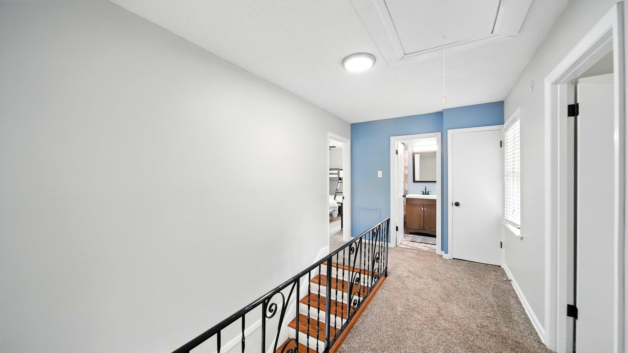 359 South Fenwick Road Memphis, TN 38111 - Photo 16 of 31 Hallway featuring light colored carpet and an upstairs landing