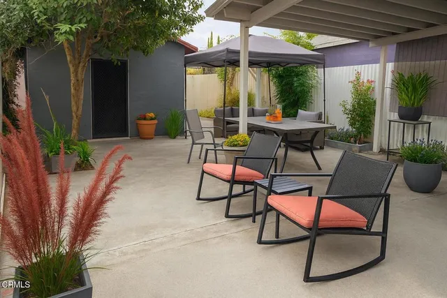 a patio with yard glass top table and chairs