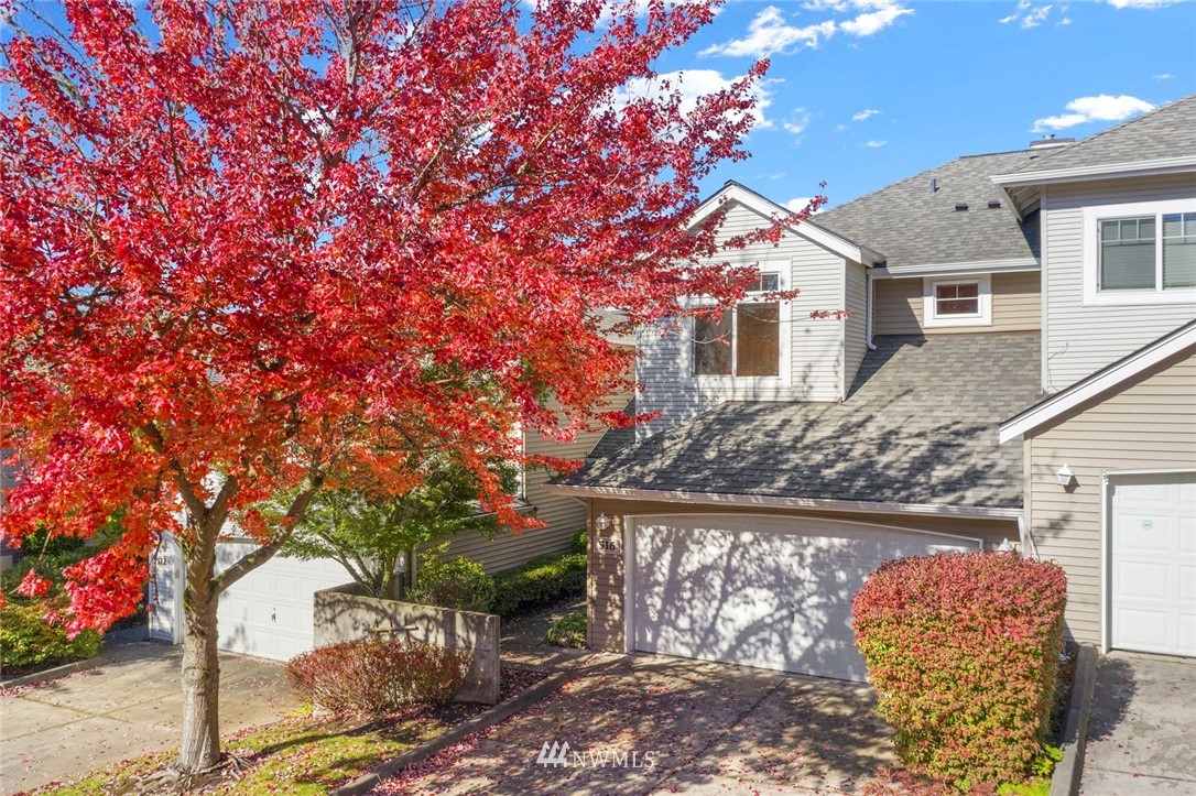 516 South 46th Place, Unit 516 Renton, WA 98055 - Photo 1 of 25 a front view of a house with a tree