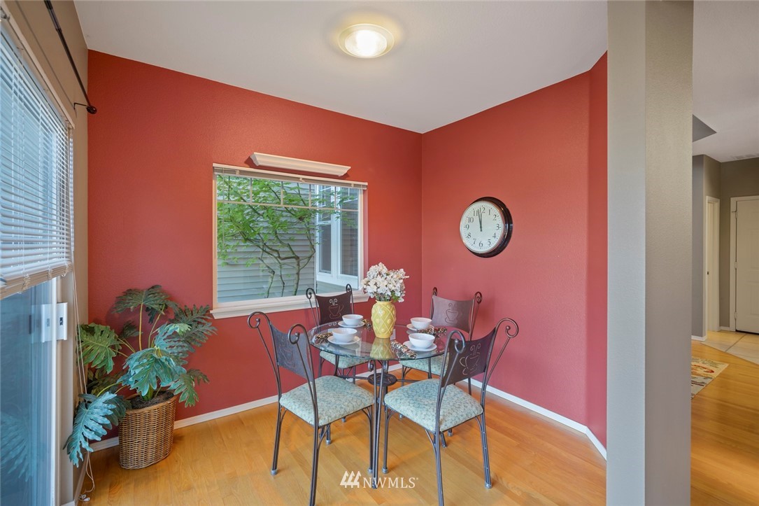 516 South 46th Place, Unit 516 Renton, WA 98055 - Photo 12 of 25 a dining room with furniture and a potted plant