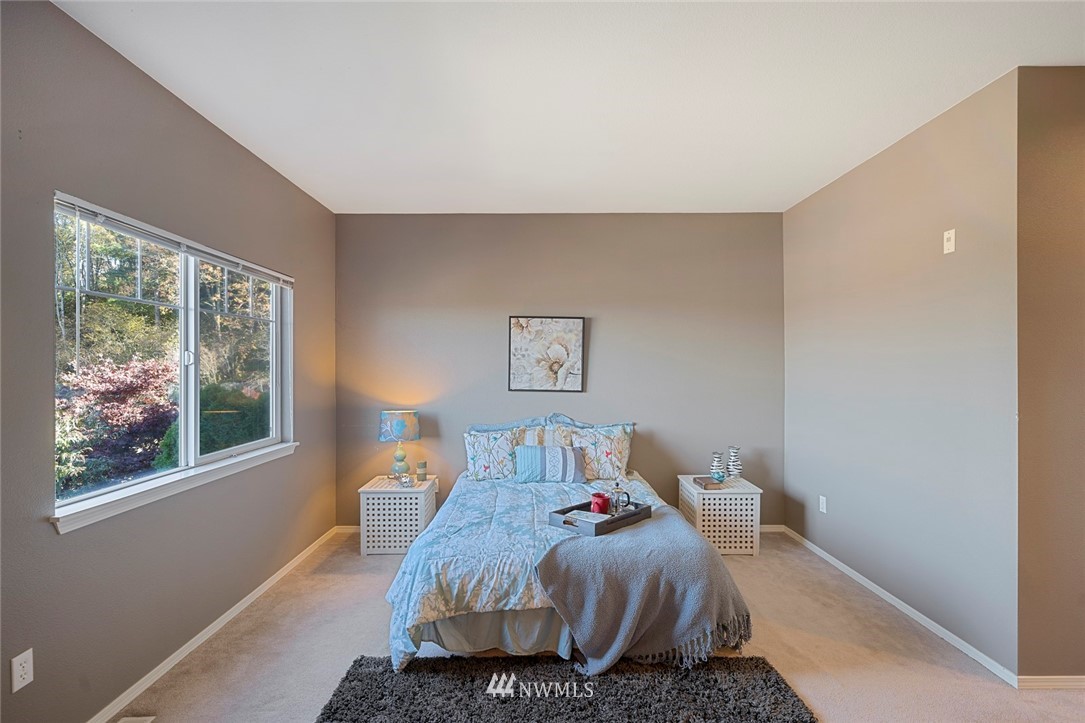 516 South 46th Place, Unit 516 Renton, WA 98055 - Photo 14 of 25 a bedroom with a bed and wooden floor