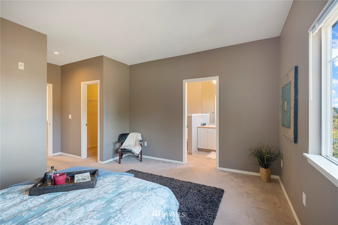 516 South 46th Place, Unit 516 Renton, WA 98055 - Photo 15 of 25 a bedroom with a bed and wooden floor