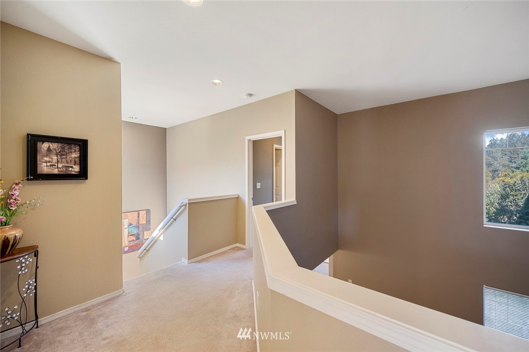 516 South 46th Place, Unit 516 Renton, WA 98055 - Photo 16 of 25 a view of a hallway with staircase and a couch