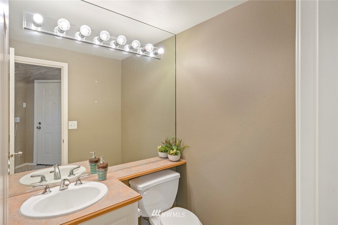 516 South 46th Place, Unit 516 Renton, WA 98055 - Photo 18 of 25 a bathroom with a sink vanity mirror and toilet