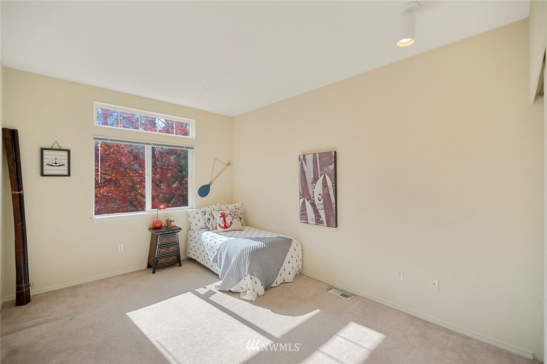 516 South 46th Place, Unit 516 Renton, WA 98055 - Photo 21 of 25 a bedroom with a bed and a window