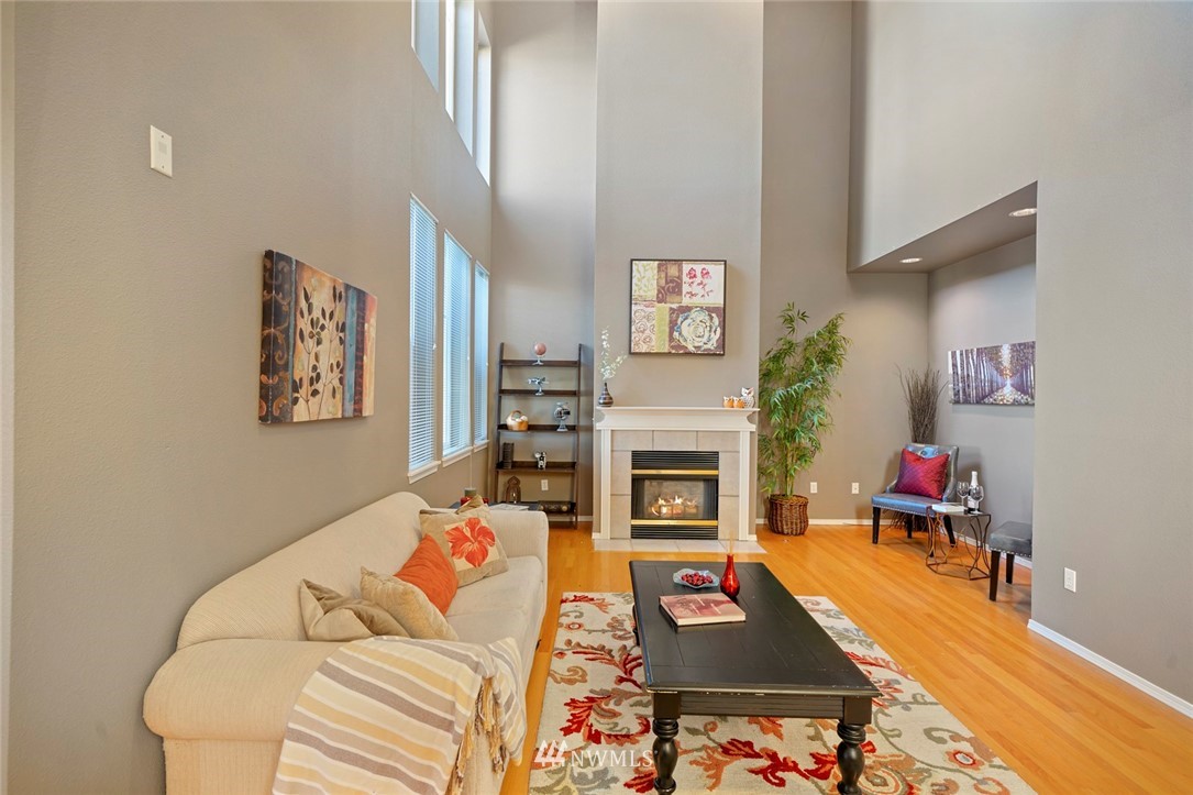 516 South 46th Place, Unit 516 Renton, WA 98055 - Photo 5 of 25 a living room with furniture and a fireplace
