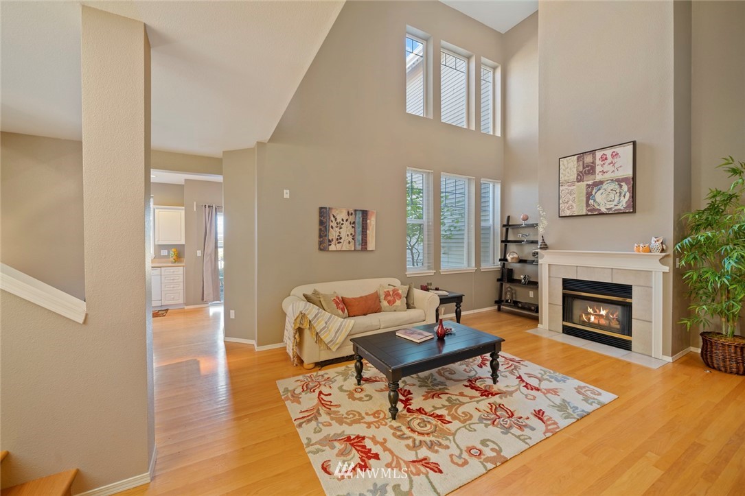 516 South 46th Place, Unit 516 Renton, WA 98055 - Photo 6 of 25 a living room with furniture and a fireplace