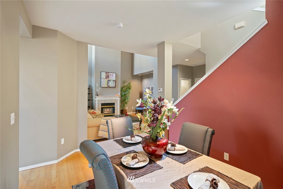 516 South 46th Place, Unit 516 Renton, WA 98055 - Photo 8 of 25 a view of a dining room with furniture and wooden floor