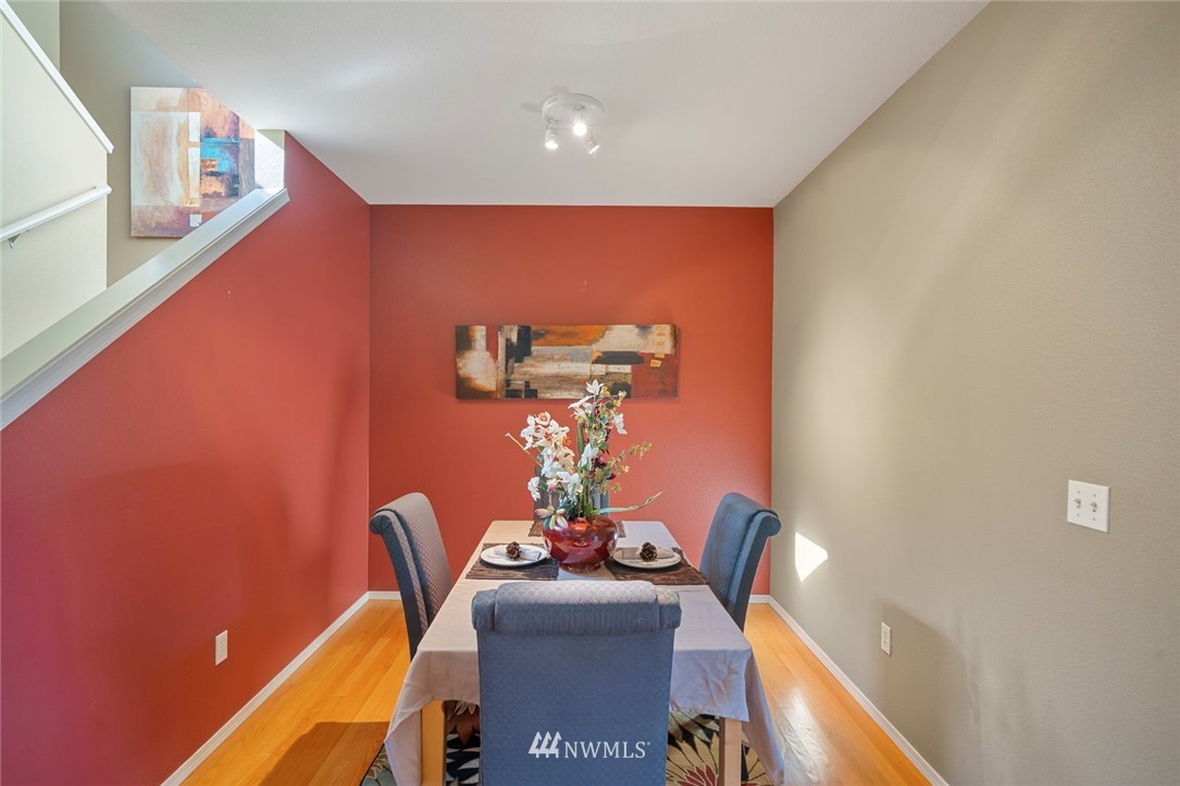 516 South 46th Place, Unit 516 Renton, WA 98055 - Photo 9 of 25 a dining room with furniture and wooden floor