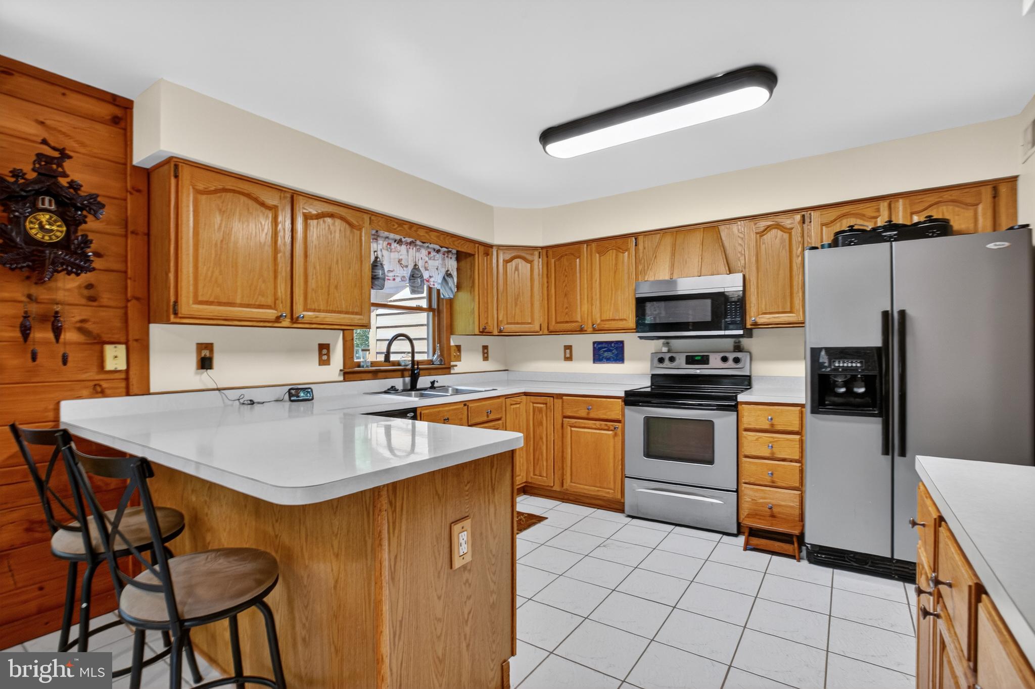 14575 Honeysuckle Way Issue, MD 20645 - Photo 5 of 49 a kitchen with stainless steel appliances granite countertop a sink a stove a refrigerator cabinets and dining table