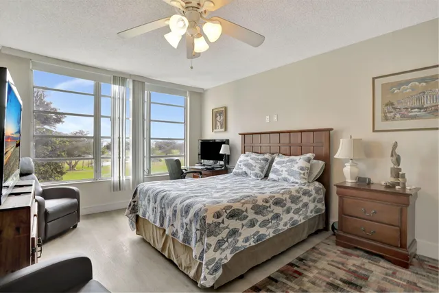 a bedroom with a large bed and a large window