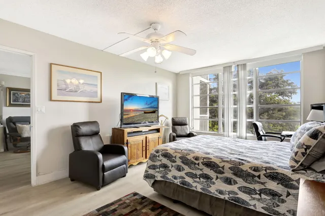 a bedroom with a bed and a chair with the view of bedroom