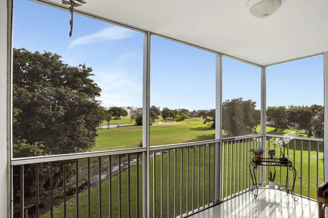 a view of a balcony next to a yard