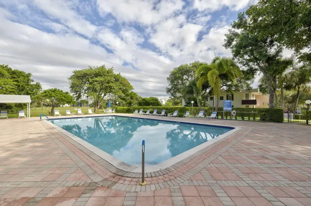 a view of swimming pool with outdoor seating and plants