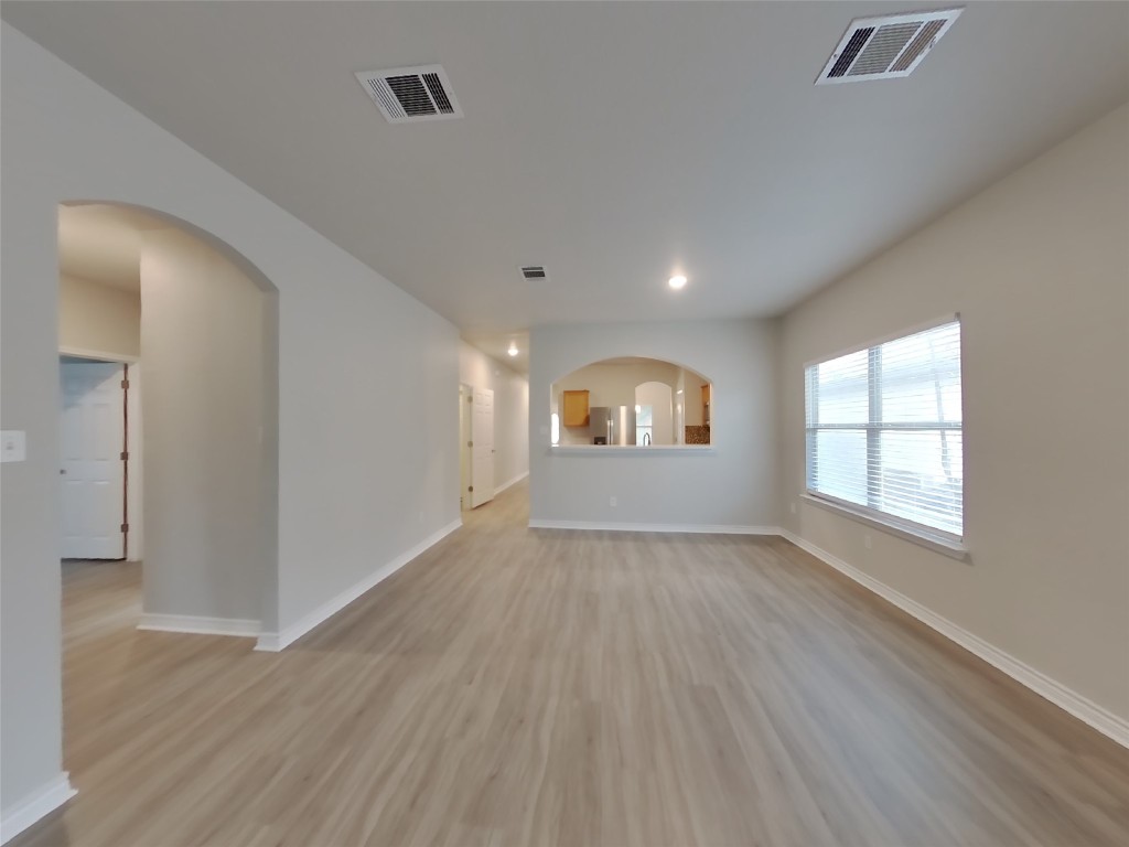 11602 Morgan's Point Street Manor, TX 78653 - Photo 2 of 17 an empty room with wooden floor and windows