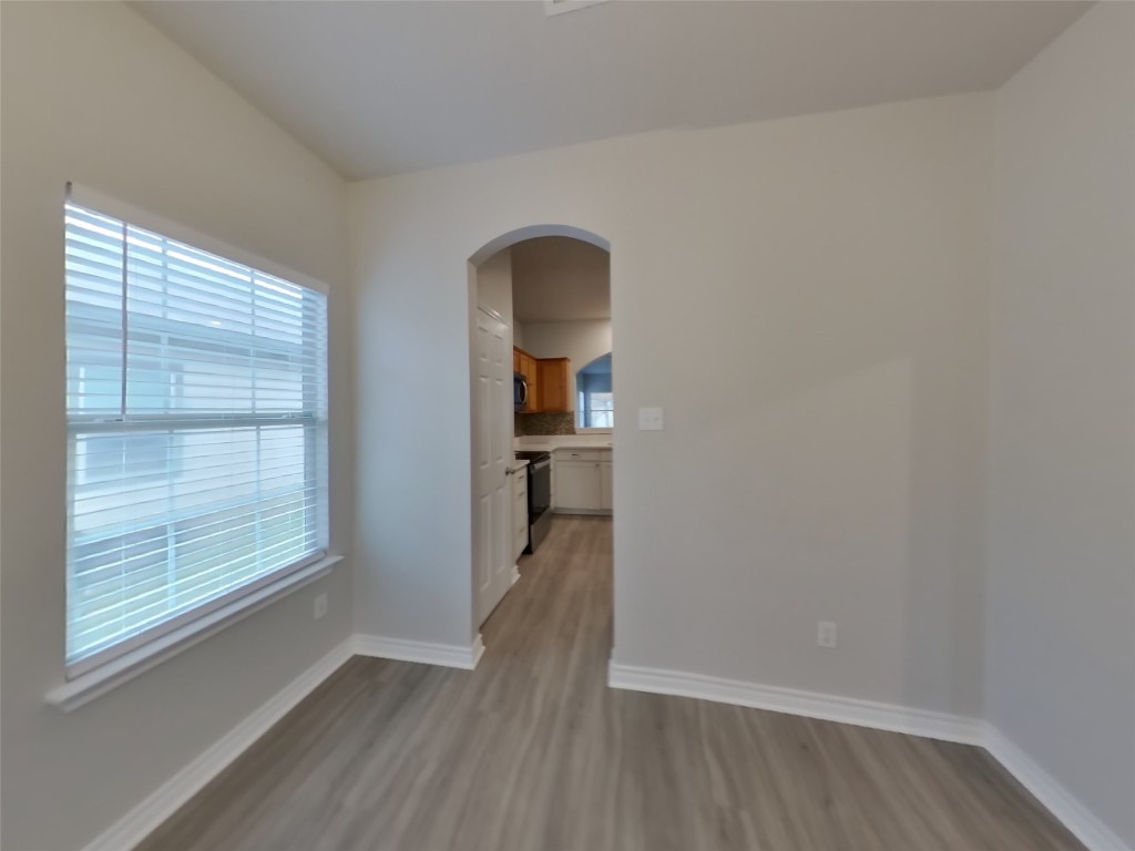 11602 Morgan's Point Street Manor, TX 78653 - Photo 4 of 17 an empty room with wooden floor and windows