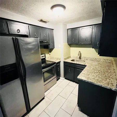 a kitchen with granite countertop cabinets and sink