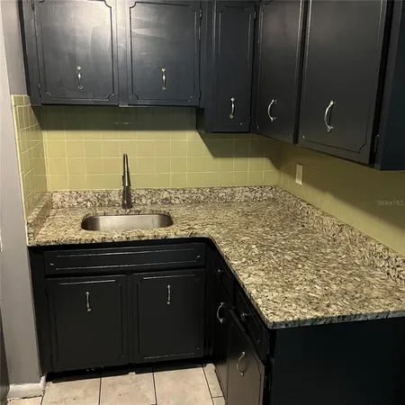 a close view of a stove top oven and cabinets