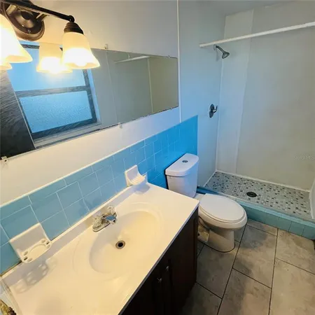 a bathroom with a sink a toilet and bathtub