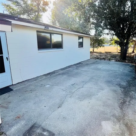 a view of a house with a large tree