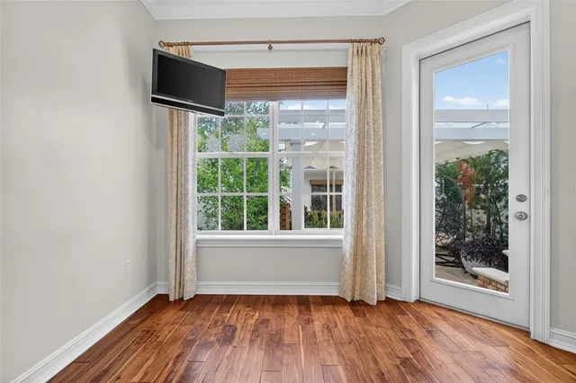 a kitchen with stainless steel appliances white cabinets a sink dishwasher a refrigerator and a stove with wooden floor