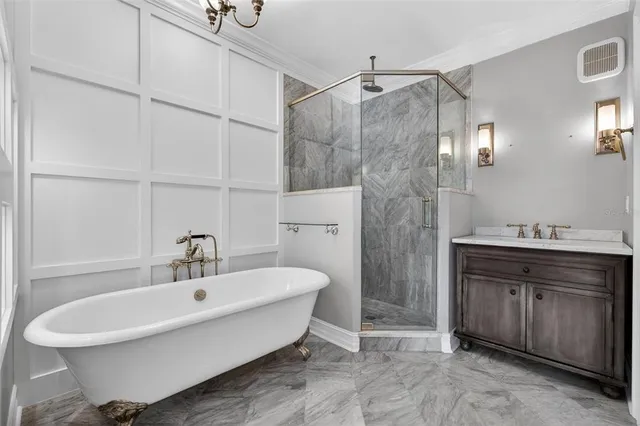 a spacious bathroom with a granite countertop sink a toilet and a mirror