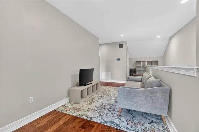 a bedroom with a bed and a night stand