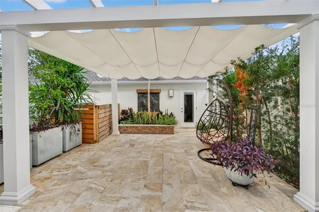 a view of a house with a large tree and a yard