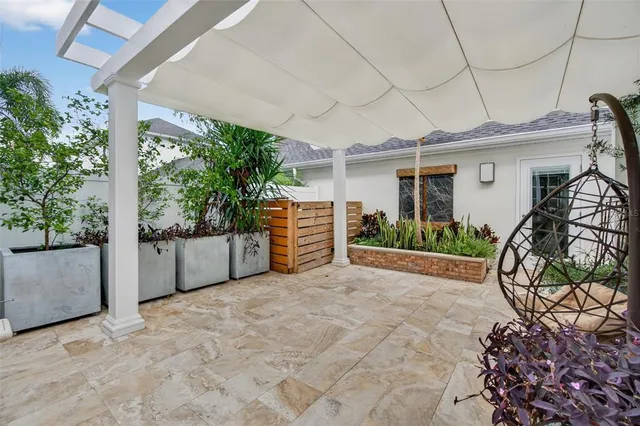 a view of a chairs and table in backyard of the house