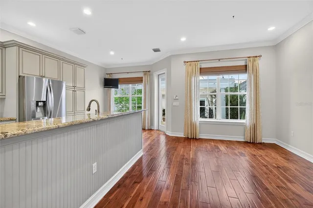 a view of kitchen with wooden floor electronic appliances and window