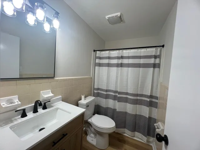 a bathroom with a sink toilet and shower