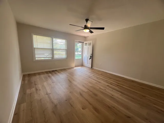 wooden floor in an empty room with a window