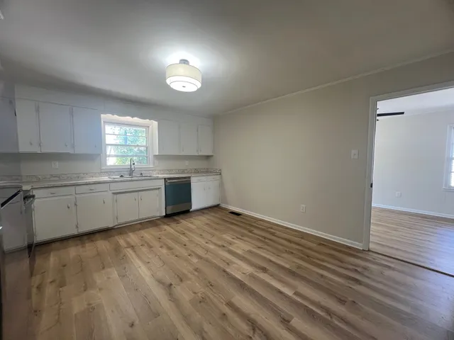 a view of a kitchen with a sink cabinets and a window