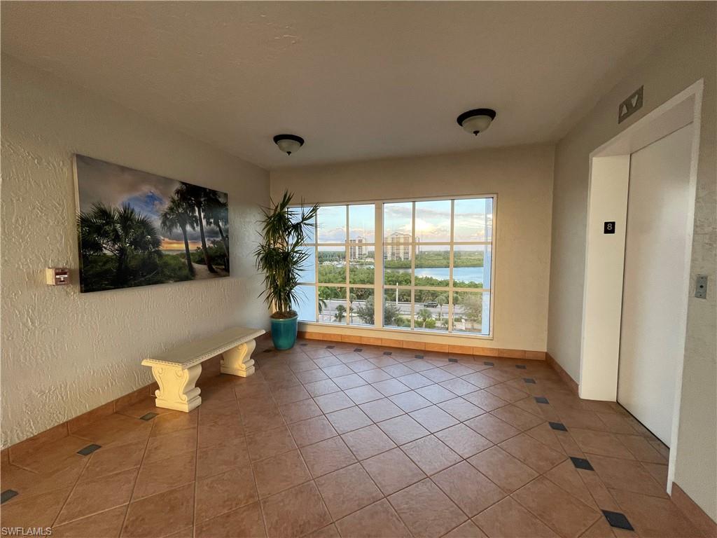 13105 Vanderbilt Drive, Unit 802 Naples, FL 34110 - Photo 30 of 32 a view of an empty room with a window