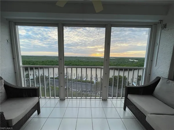 a living room with a large window and a table