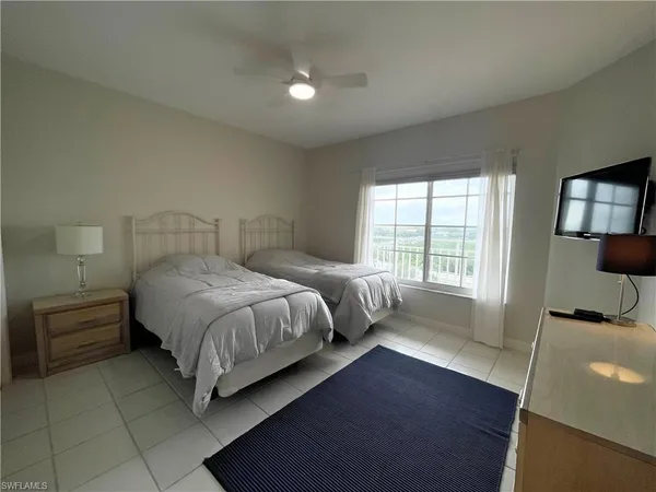 a bedroom with a bed and large window