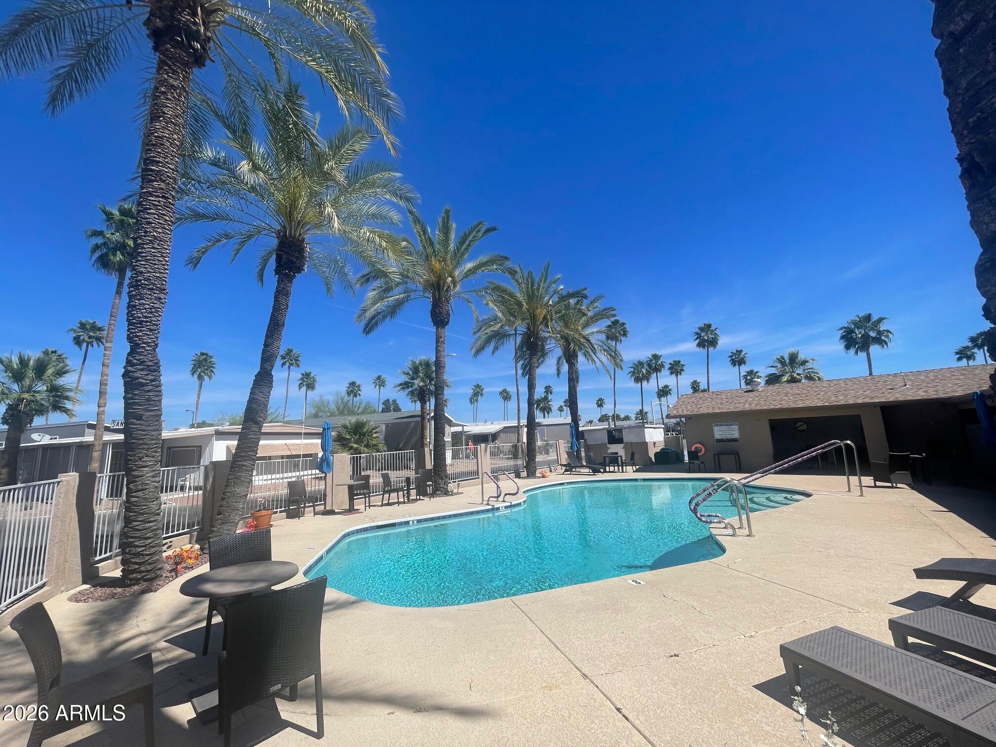 16225 North Cave Creek Road, Unit 31 Phoenix, AZ 85032 - Photo 18 of 33 a swimming pool with outdoor seating and yard