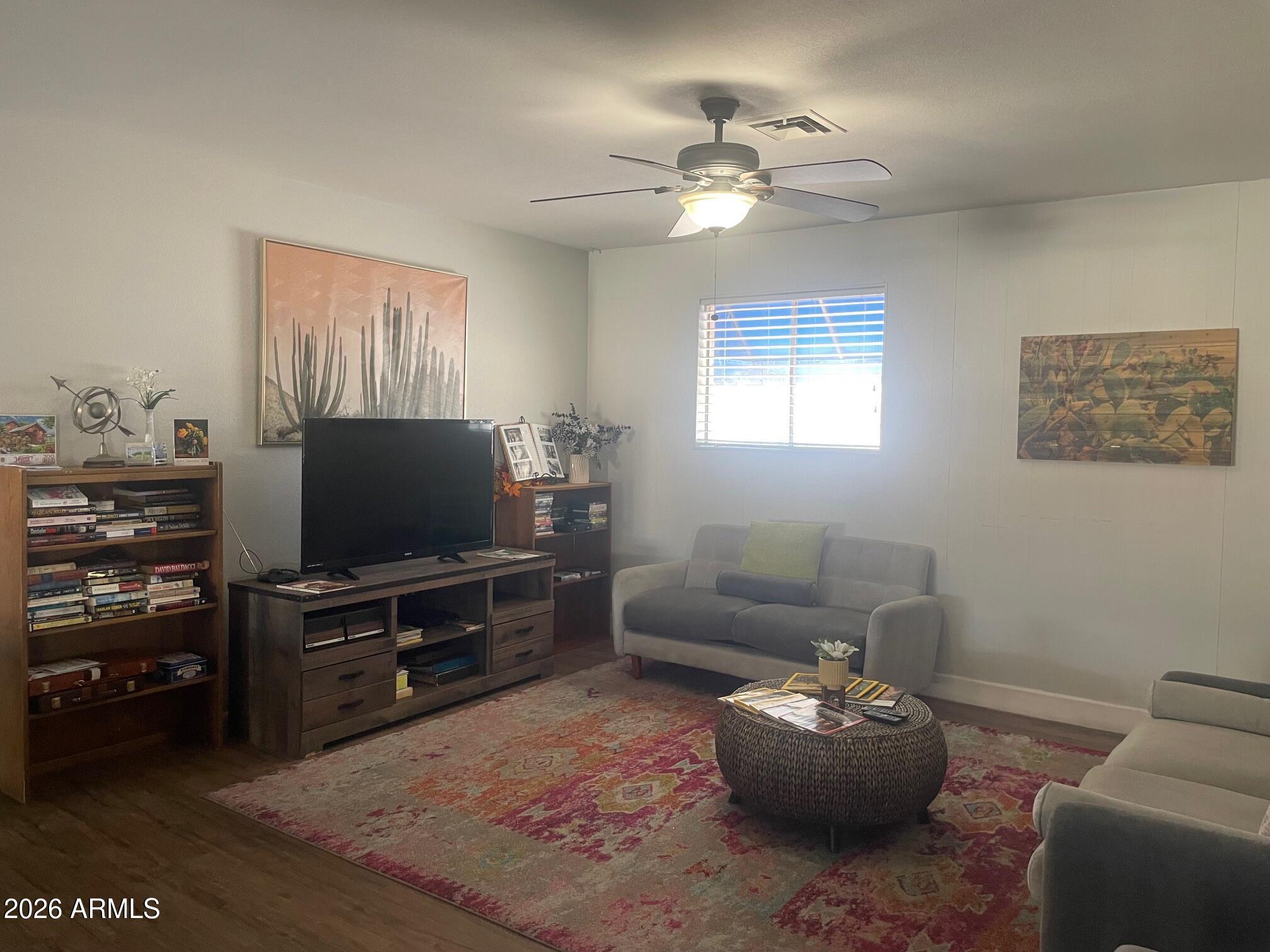 16225 North Cave Creek Road, Unit 31 Phoenix, AZ 85032 - Photo 22 of 33 a living room with furniture and a flat screen tv